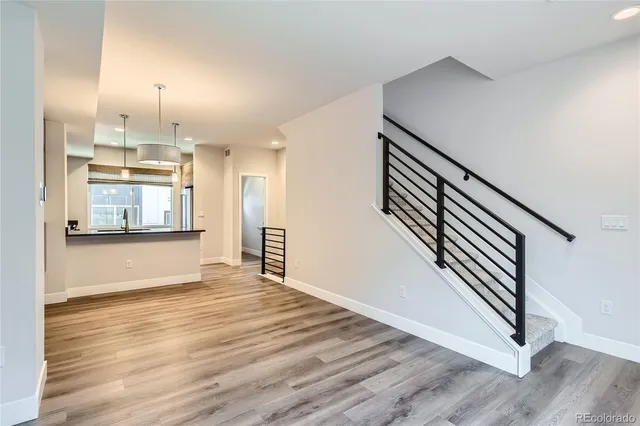a view of kitchen and hall with wooden floor