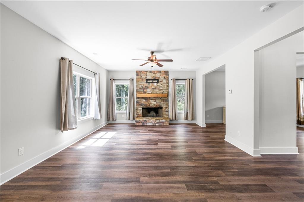 1701 Trotters Court Monroe, GA 30656 - Photo 11 of 41 a view of an empty room with wooden floor fireplace and a window