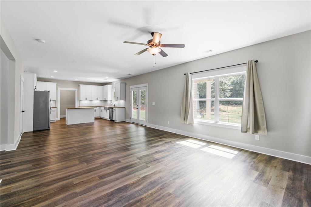 1701 Trotters Court Monroe, GA 30656 - Photo 13 of 41 a view of an empty room with window and wooden floor