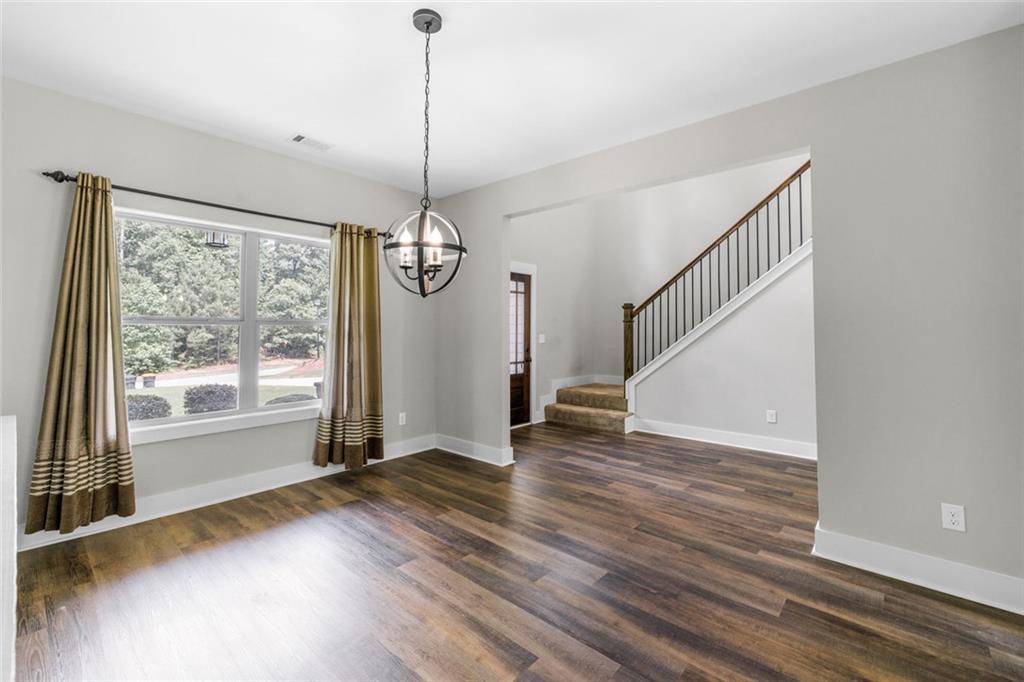 1701 Trotters Court Monroe, GA 30656 - Photo 14 of 41 a view of an empty room with wooden floor and a window
