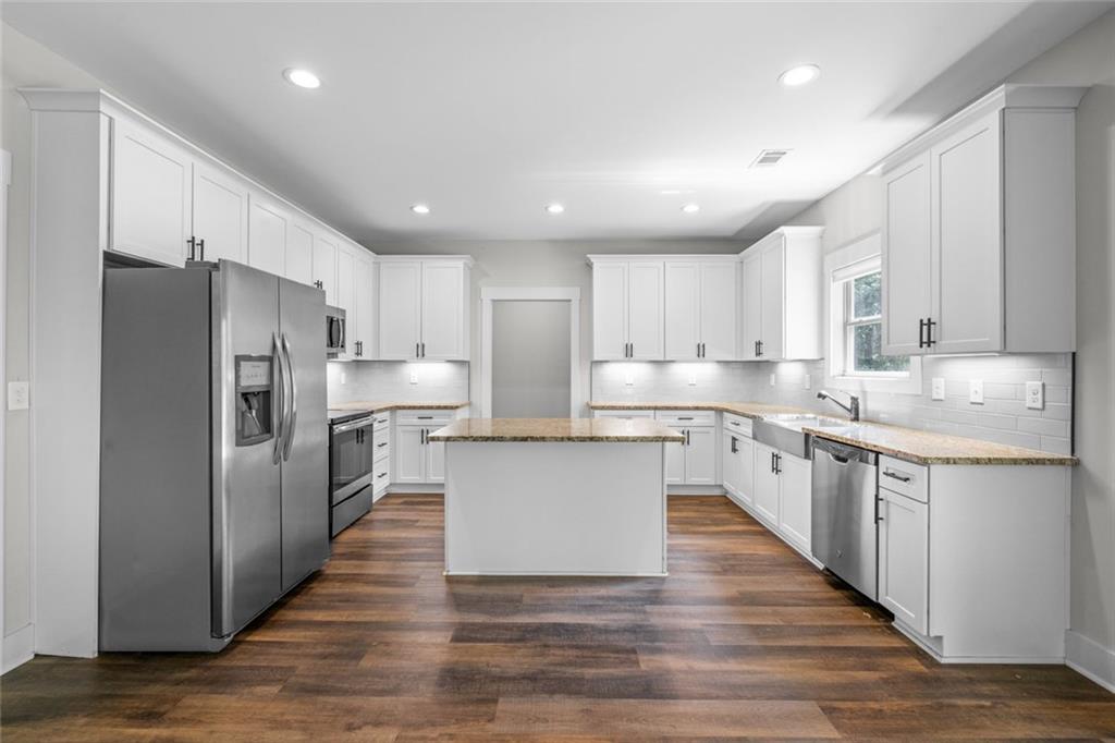 1701 Trotters Court Monroe, GA 30656 - Photo 15 of 41 a large kitchen with stainless steel appliances sink a microwave and cabinets