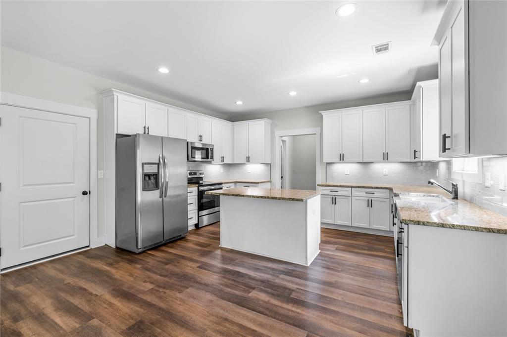 1701 Trotters Court Monroe, GA 30656 - Photo 17 of 41 a kitchen with stainless steel appliances granite countertop a refrigerator sink and cabinets