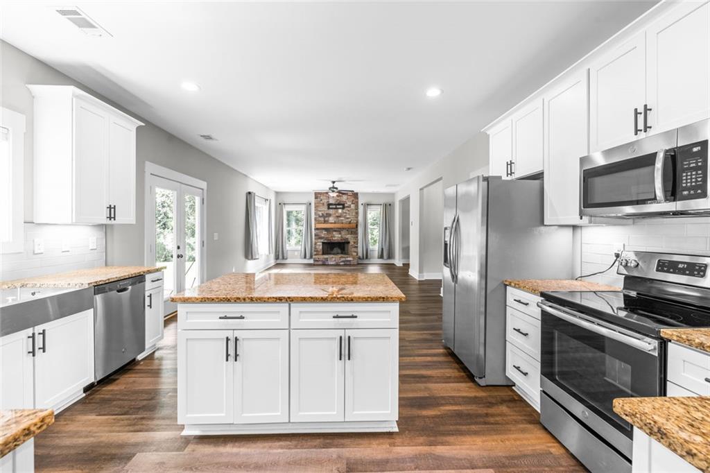 1701 Trotters Court Monroe, GA 30656 - Photo 18 of 41 a kitchen with stainless steel appliances granite countertop a stove a sink and a refrigerator