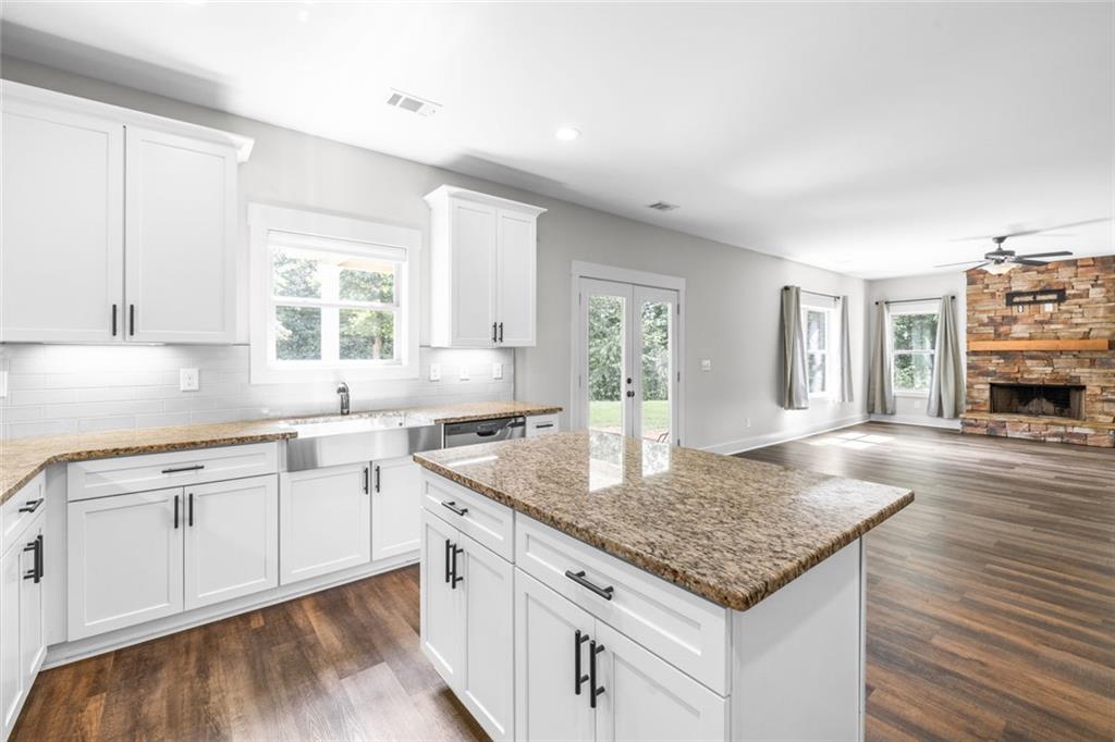 1701 Trotters Court Monroe, GA 30656 - Photo 19 of 41 a kitchen with granite countertop a sink a counter top space and cabinets