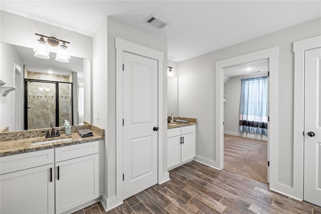 1701 Trotters Court Monroe, GA 30656 - Photo 26 of 41 a spacious bathroom with a granite countertop sink and a mirror