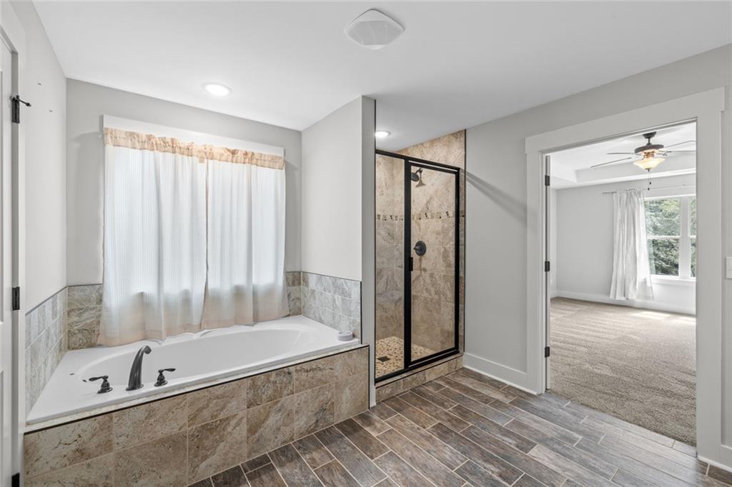 1701 Trotters Court Monroe, GA 30656 - Photo 27 of 41 a bathroom with a tub and a shower