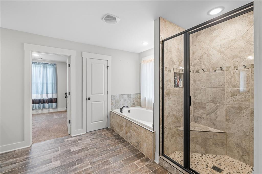 1701 Trotters Court Monroe, GA 30656 - Photo 28 of 41 a spacious bathroom with a bathtub and a shower