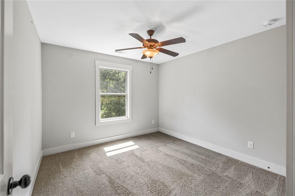 1701 Trotters Court Monroe, GA 30656 - Photo 34 of 41 an empty room with windows and fan