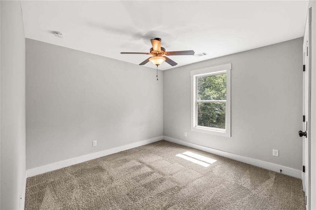 1701 Trotters Court Monroe, GA 30656 - Photo 35 of 41 wooden floor in an empty room with a window