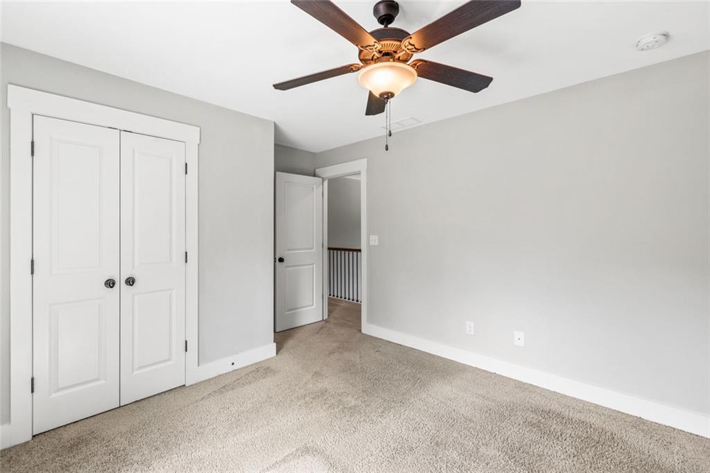 1701 Trotters Court Monroe, GA 30656 - Photo 36 of 41 an empty room with a ceiling fan and a window