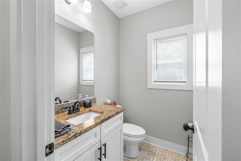 1701 Trotters Court Monroe, GA 30656 - Photo 37 of 41 a bathroom with a granite countertop sink toilet and mirror