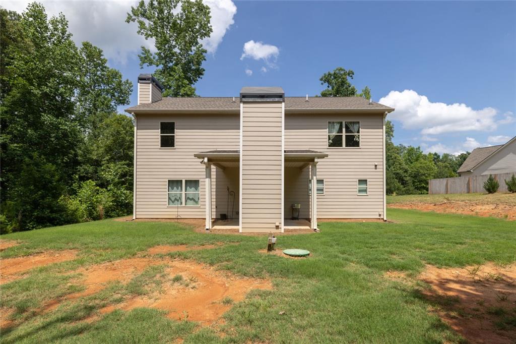 1701 Trotters Court Monroe, GA 30656 - Photo 4 of 41 a front view of a house with a garden