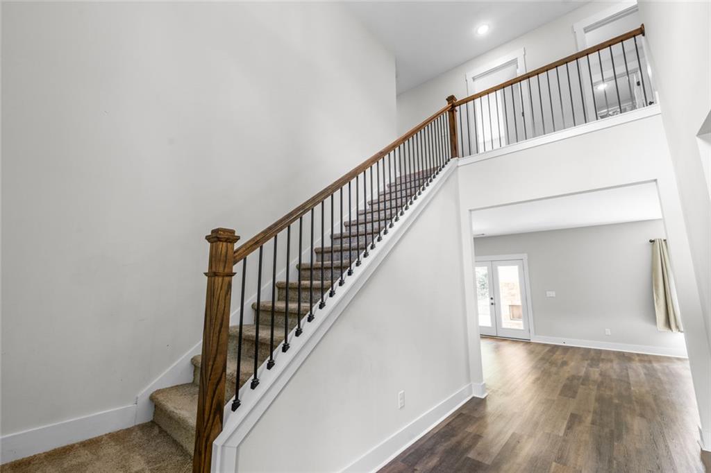 1701 Trotters Court Monroe, GA 30656 - Photo 8 of 41 a view of staircase with wooden floor and a rug