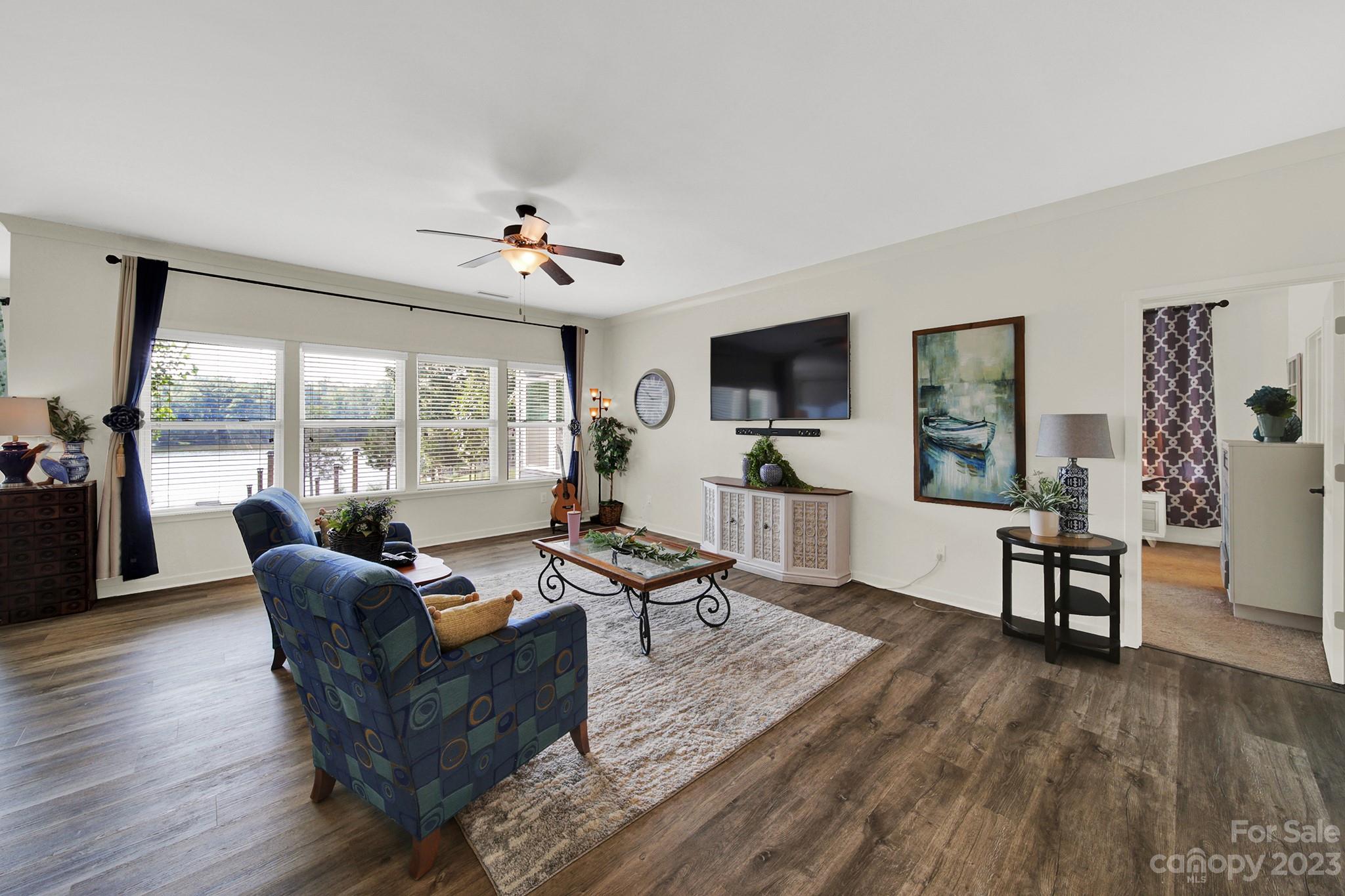 25554 Seagull Drive Lancaster, SC 29720 - Photo 12 of 33 a living room with furniture a flat screen tv and a floor to ceiling window
