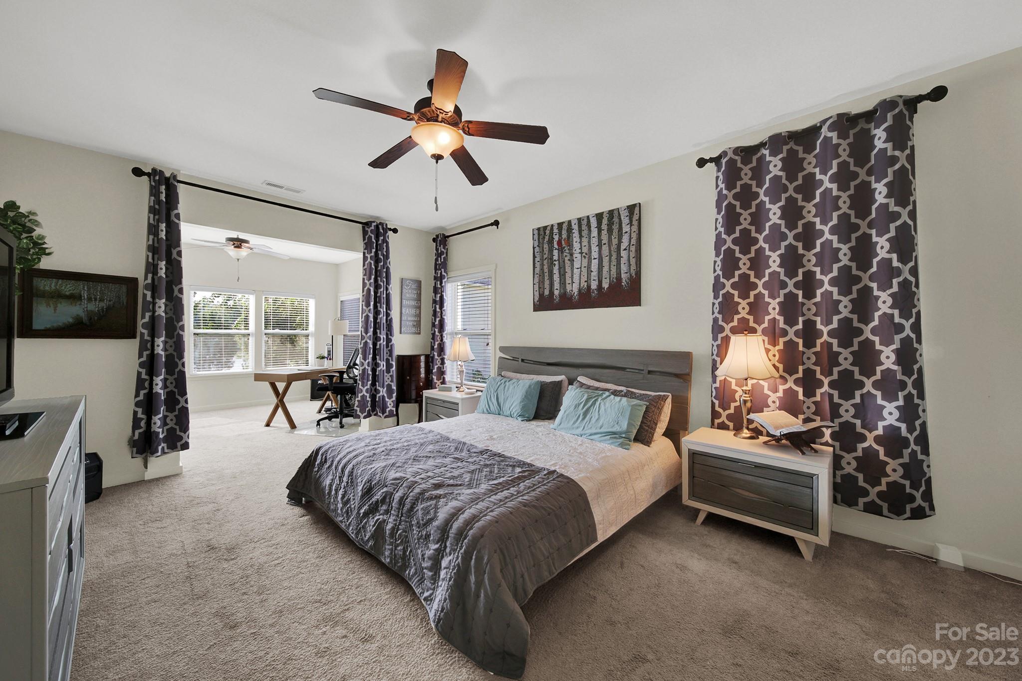 25554 Seagull Drive Lancaster, SC 29720 - Photo 19 of 33 a spacious bedroom with a bed and a chandelier