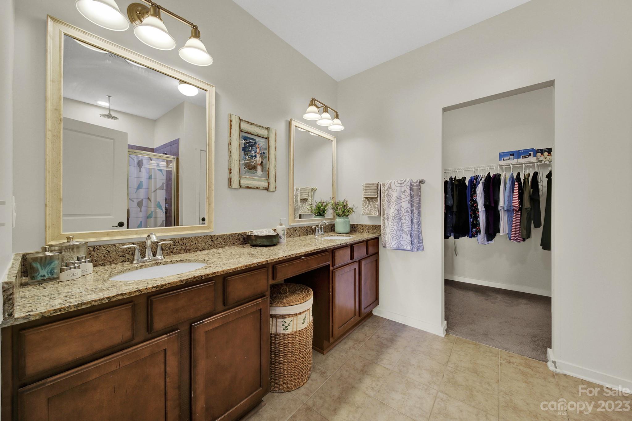 25554 Seagull Drive Lancaster, SC 29720 - Photo 22 of 33 a bathroom with a double vanity sink and a mirror