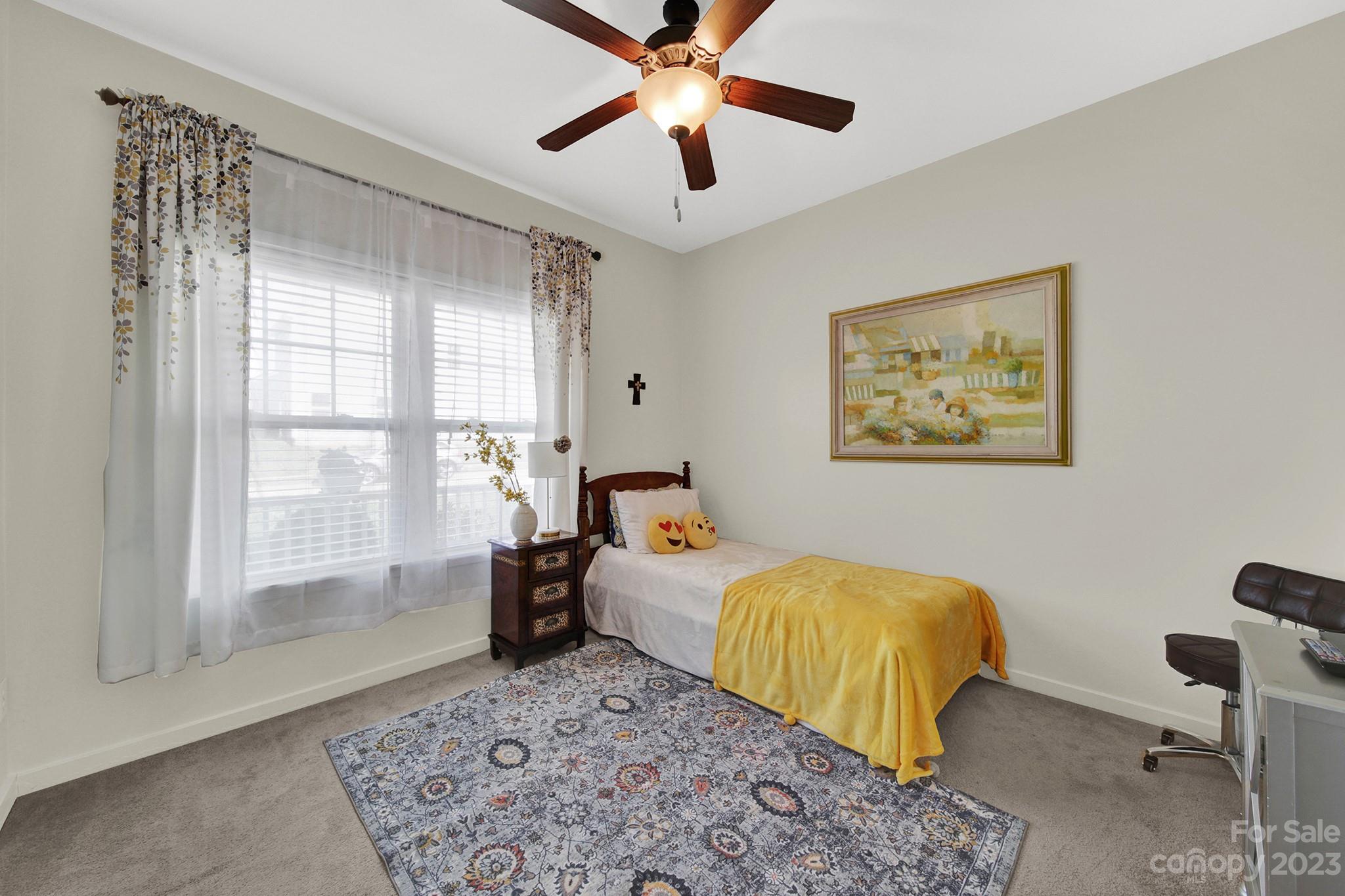 25554 Seagull Drive Lancaster, SC 29720 - Photo 6 of 33 a bedroom with a bed and a chandelier