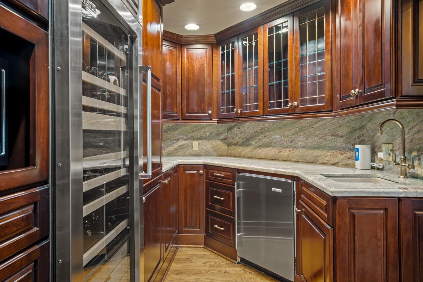 3017 Cormorant Road Pebble Beach, CA 93953 - Photo 11 of 42 a kitchen with stainless steel appliances granite countertop a sink and a microwave
