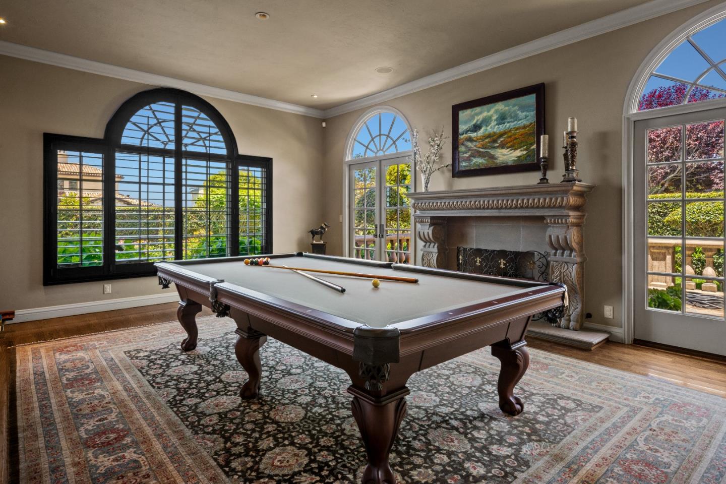3017 Cormorant Road Pebble Beach, CA 93953 - Photo 15 of 42 a living room with a table chairs and a fireplace