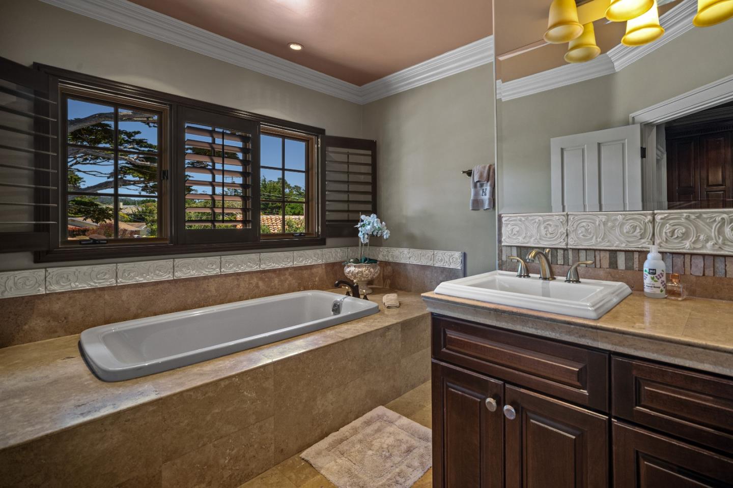 3017 Cormorant Road Pebble Beach, CA 93953 - Photo 19 of 42 a bathroom with a tub a sink and large window