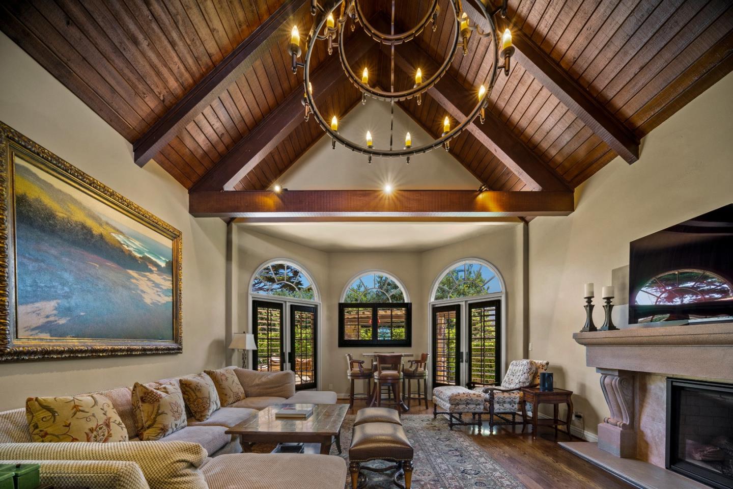 3017 Cormorant Road Pebble Beach, CA 93953 - Photo 4 of 42 a living room with furniture a fireplace and a flat screen tv