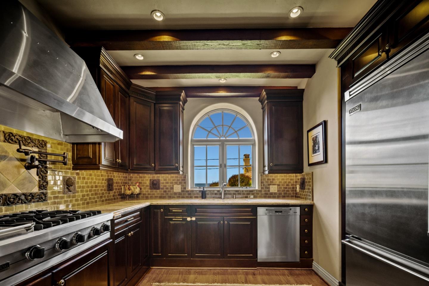 3017 Cormorant Road Pebble Beach, CA 93953 - Photo 6 of 42 a kitchen with stainless steel appliances granite countertop a stove and a sink