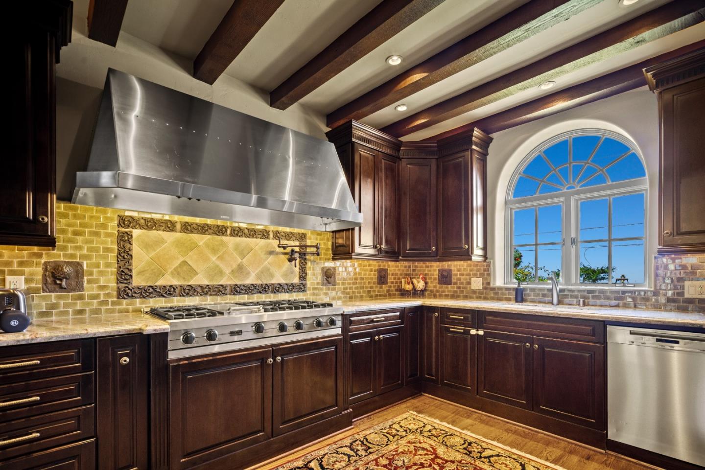3017 Cormorant Road Pebble Beach, CA 93953 - Photo 7 of 42 a kitchen with stainless steel appliances granite countertop a sink stove and cabinets