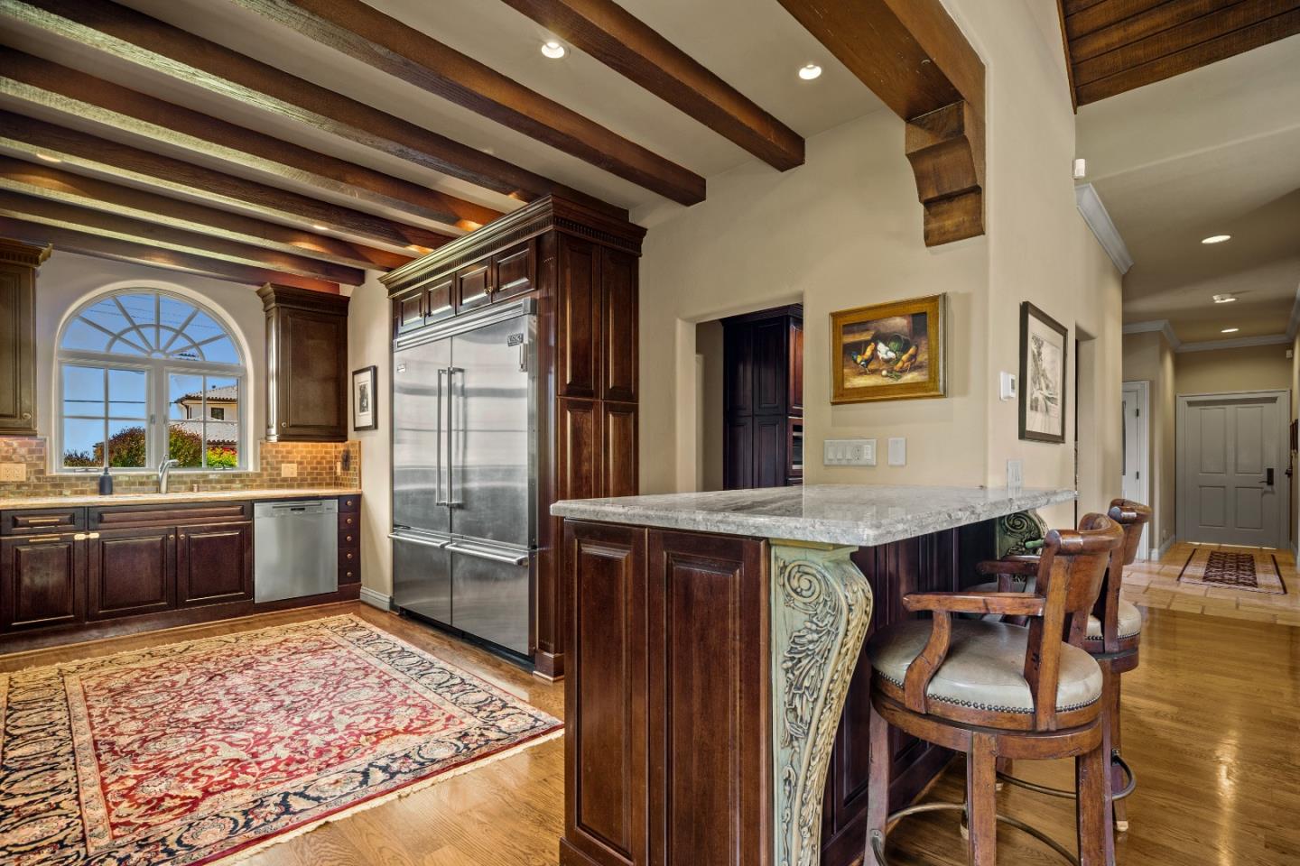 3017 Cormorant Road Pebble Beach, CA 93953 - Photo 9 of 42 a kitchen with a table and chairs in it