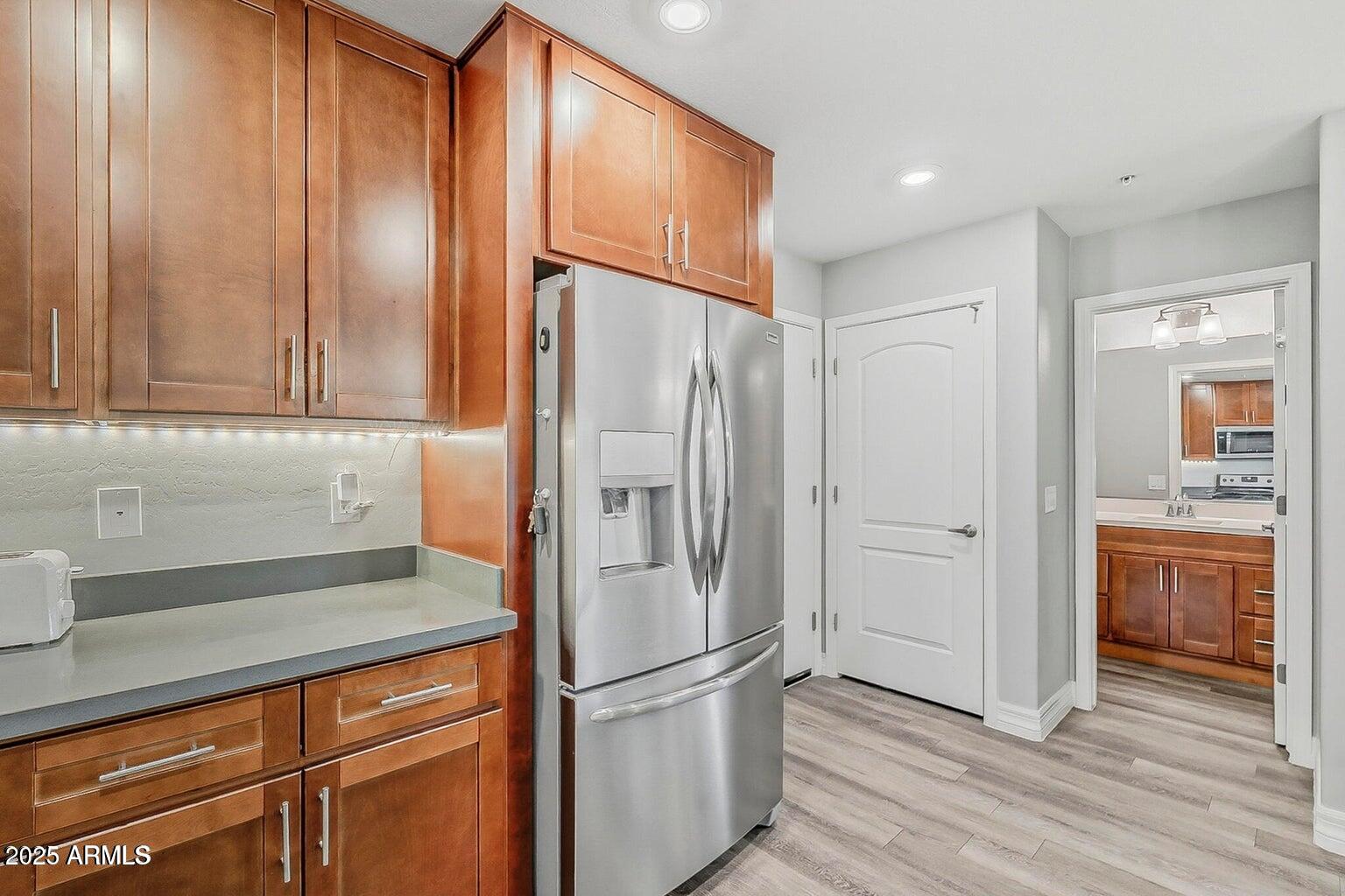 2821 South Skyline Drive, Unit 141 Mesa, AZ 85212 - Photo 13 of 68 a kitchen with stainless steel appliances granite countertop a refrigerator and a sink