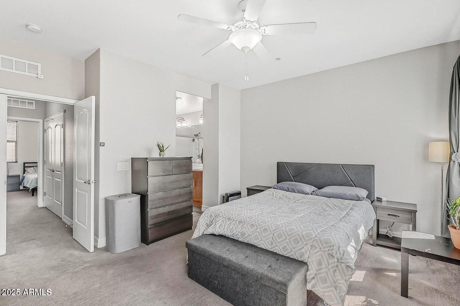 2821 South Skyline Drive, Unit 141 Mesa, AZ 85212 - Photo 17 of 68 a bedroom with a bed and a cabinets