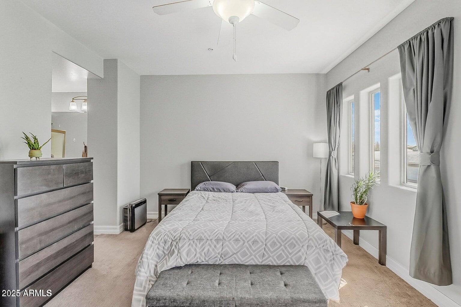2821 South Skyline Drive, Unit 141 Mesa, AZ 85212 - Photo 18 of 68 a bedroom with a bed and a dresser