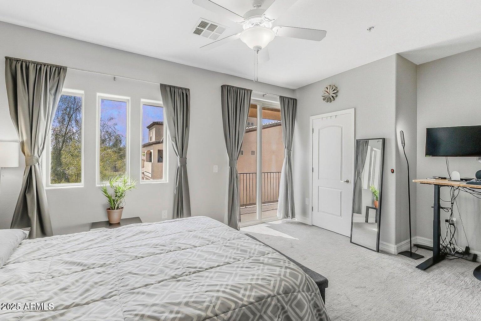 2821 South Skyline Drive, Unit 141 Mesa, AZ 85212 - Photo 20 of 68 a bedroom with a bed and a chandelier