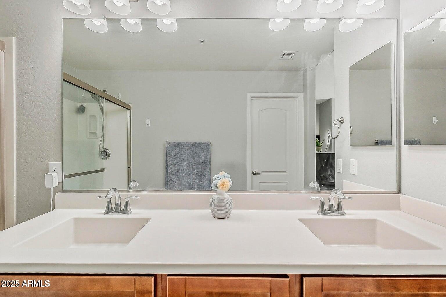 2821 South Skyline Drive, Unit 141 Mesa, AZ 85212 - Photo 25 of 68 a bathroom with a sink double vanity and a mirror