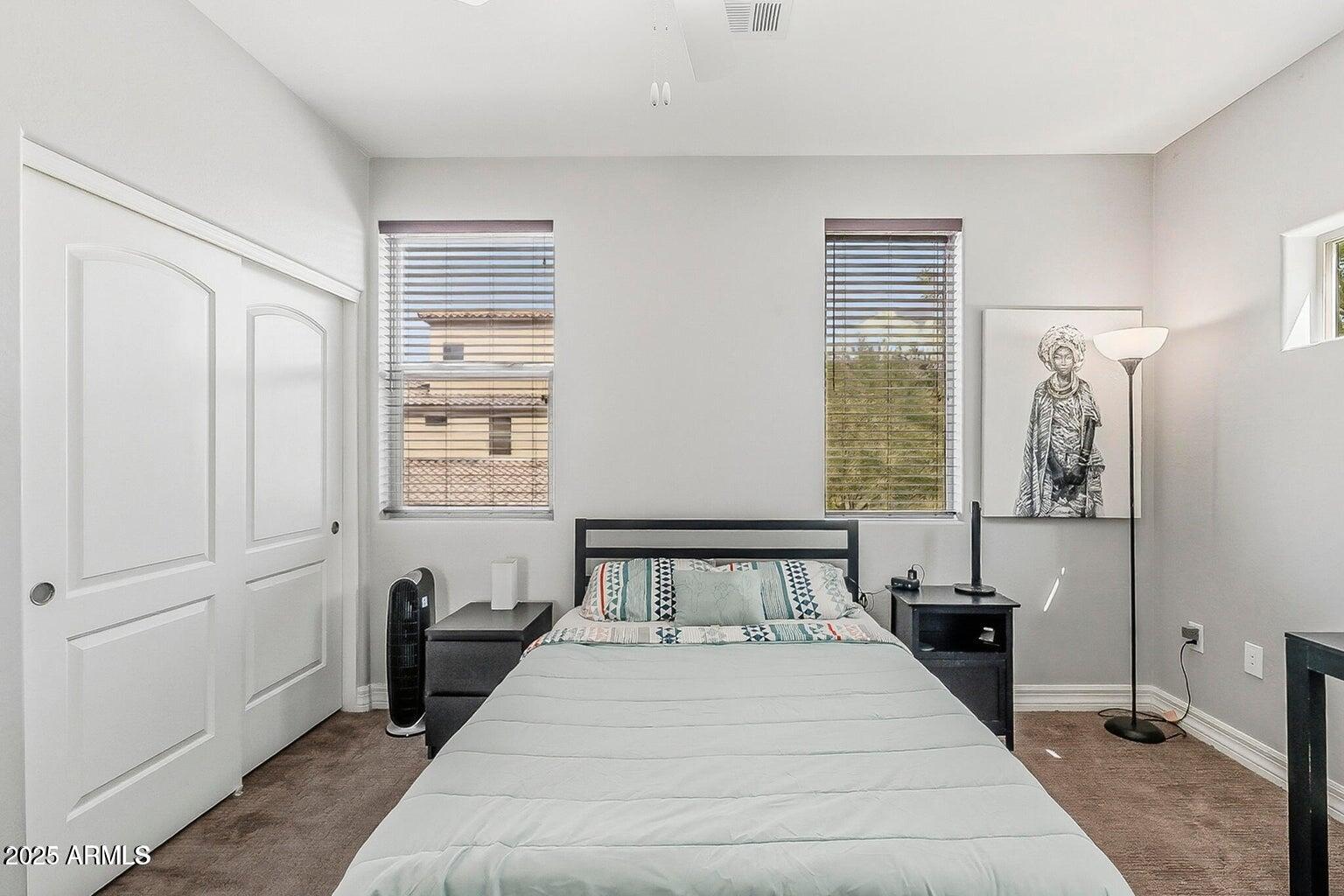 2821 South Skyline Drive, Unit 141 Mesa, AZ 85212 - Photo 27 of 68 a bedroom with a bed and wooden floor