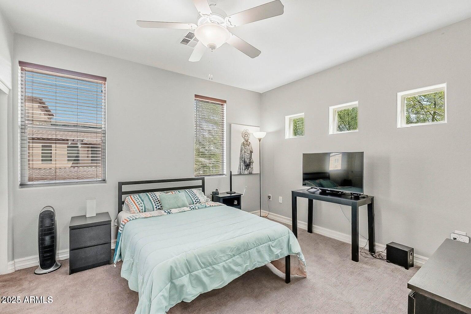 2821 South Skyline Drive, Unit 141 Mesa, AZ 85212 - Photo 28 of 68 a bedroom with a bed and a flat screen tv