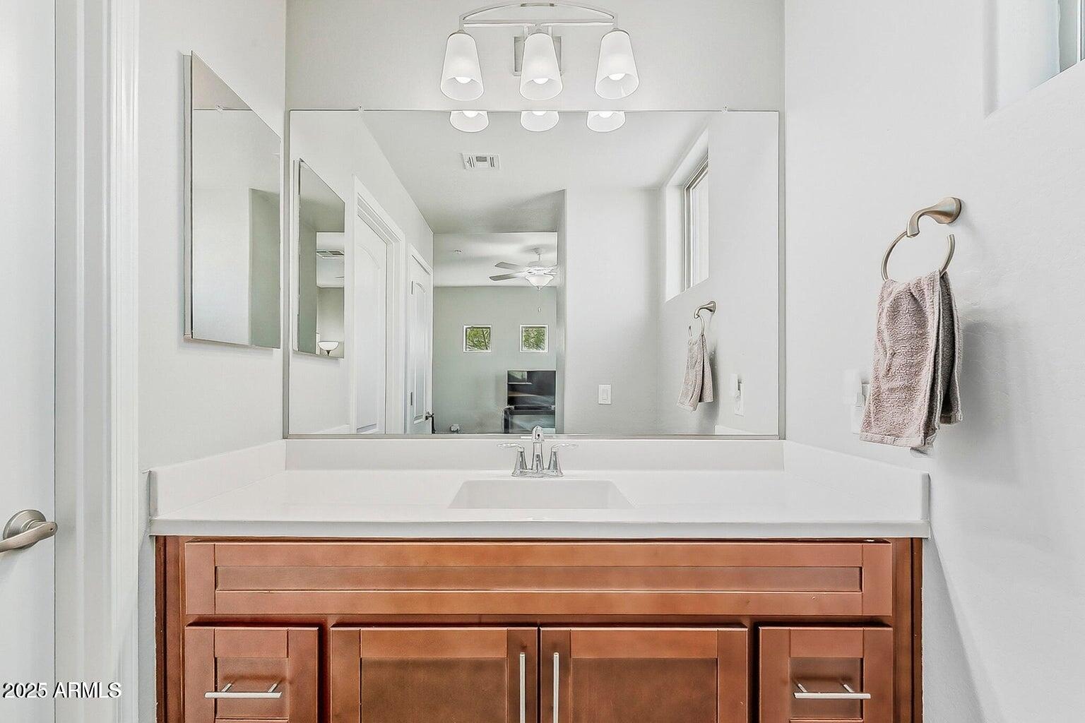 2821 South Skyline Drive, Unit 141 Mesa, AZ 85212 - Photo 31 of 68 a bathroom with a sink and a mirror
