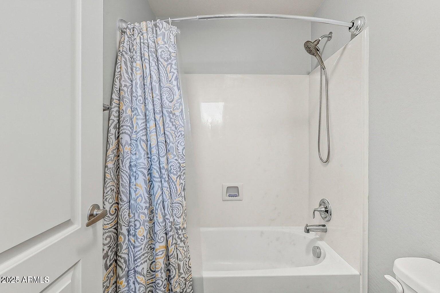 2821 South Skyline Drive, Unit 141 Mesa, AZ 85212 - Photo 32 of 68 a bathroom with a shower curtain and a shower curtain