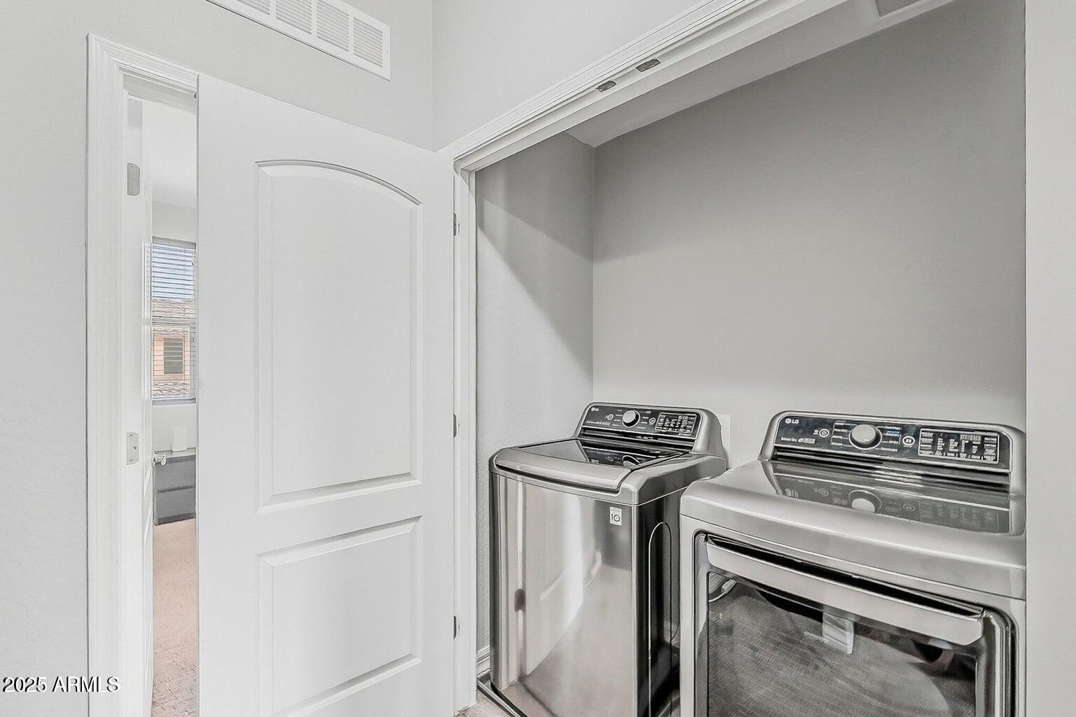 2821 South Skyline Drive, Unit 141 Mesa, AZ 85212 - Photo 33 of 68 a view of storage and utility room with washer and dryer