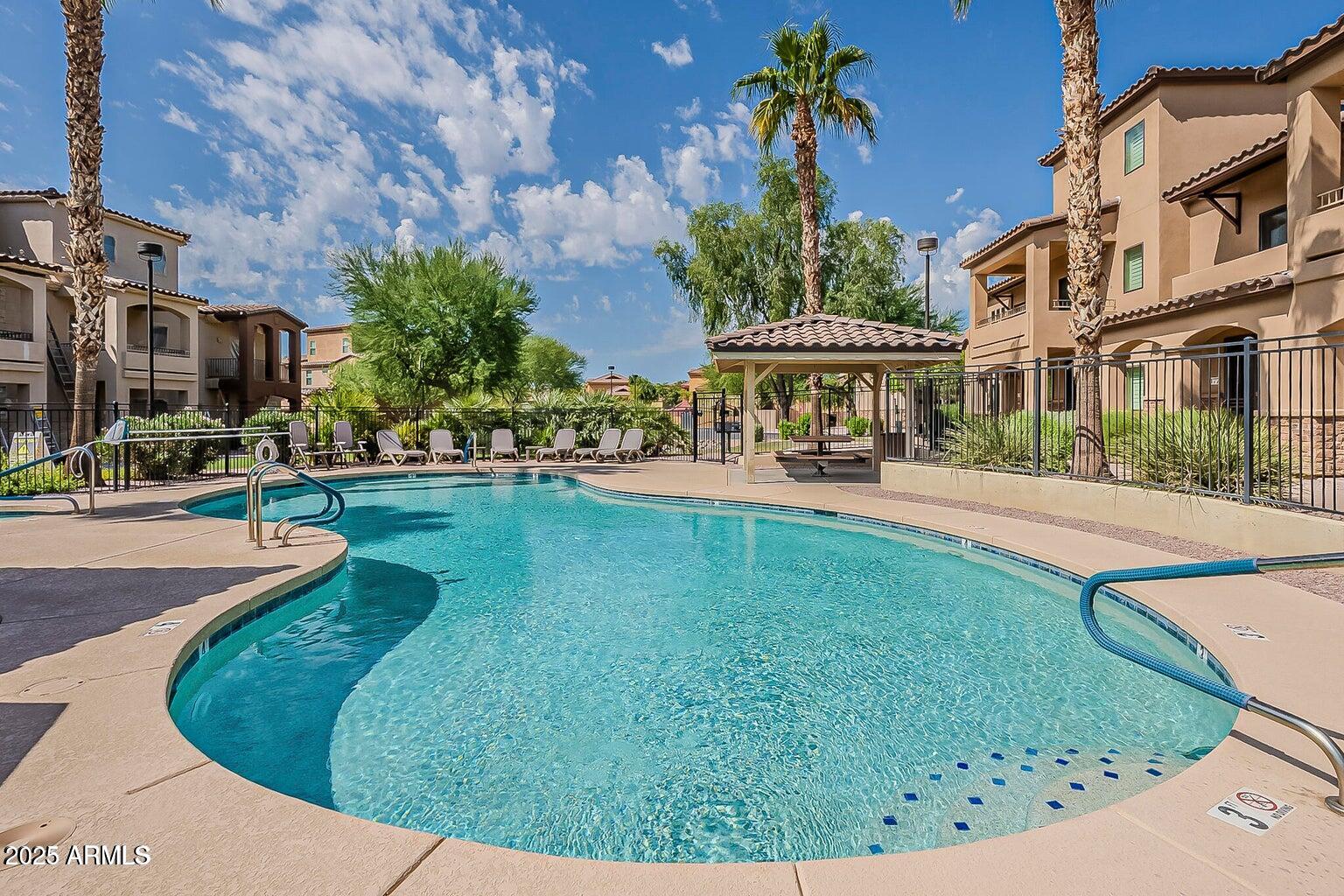 2821 South Skyline Drive, Unit 141 Mesa, AZ 85212 - Photo 39 of 68 a view of a street with a building in the background
