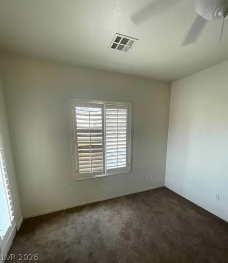 677 Principle Point Avenue Henderson, NV 89012 - Photo 20 of 40 Spare room featuring dark colored carpet and ceiling fan