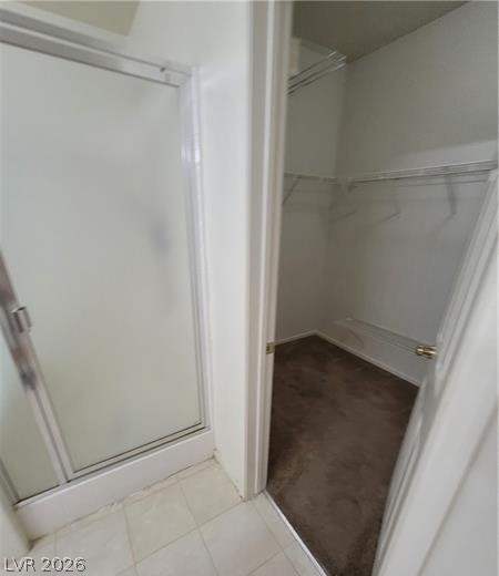677 Principle Point Avenue Henderson, NV 89012 - Photo 21 of 40 Full bath featuring a walk in closet and a shower stall