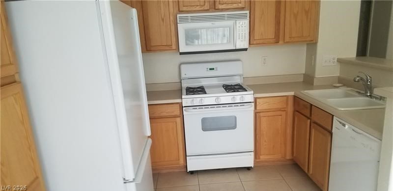677 Principle Point Avenue Henderson, NV 89012 - Photo 9 of 40 Kitchen with white appliances, light countertops, and light tile patterned flooring