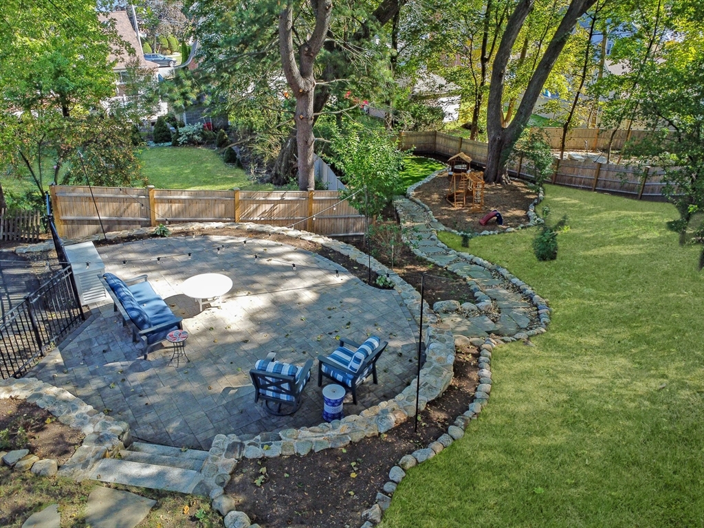 a view of a backyard with table and chairs