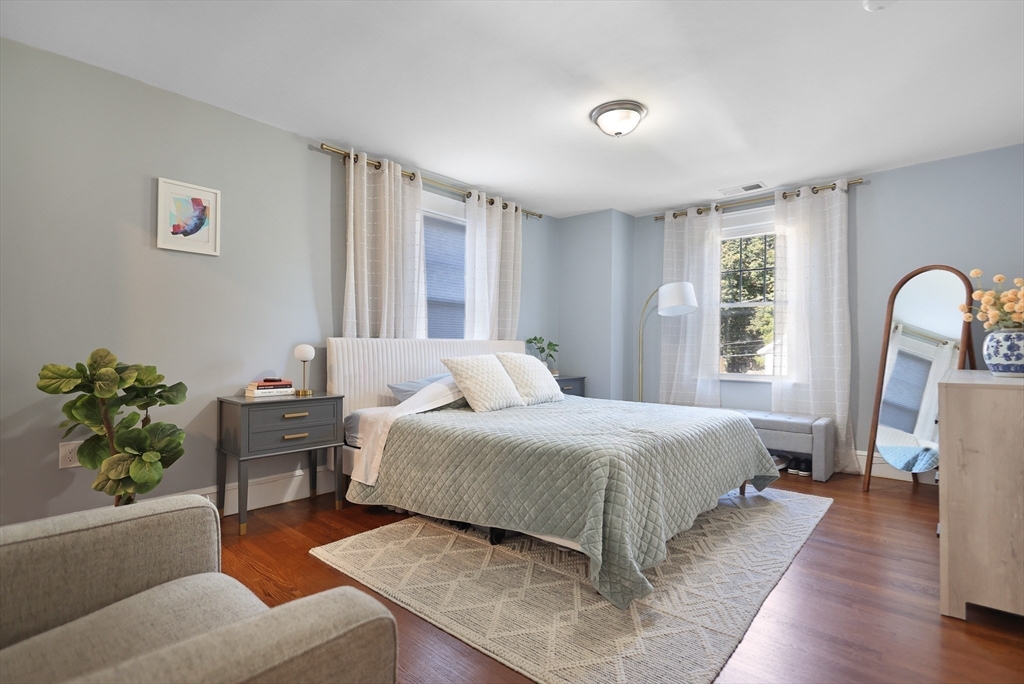 15 Whitman Road Medford, MA 02155 - Photo 14 of 39 a bedroom with a bed wooden floor and window
