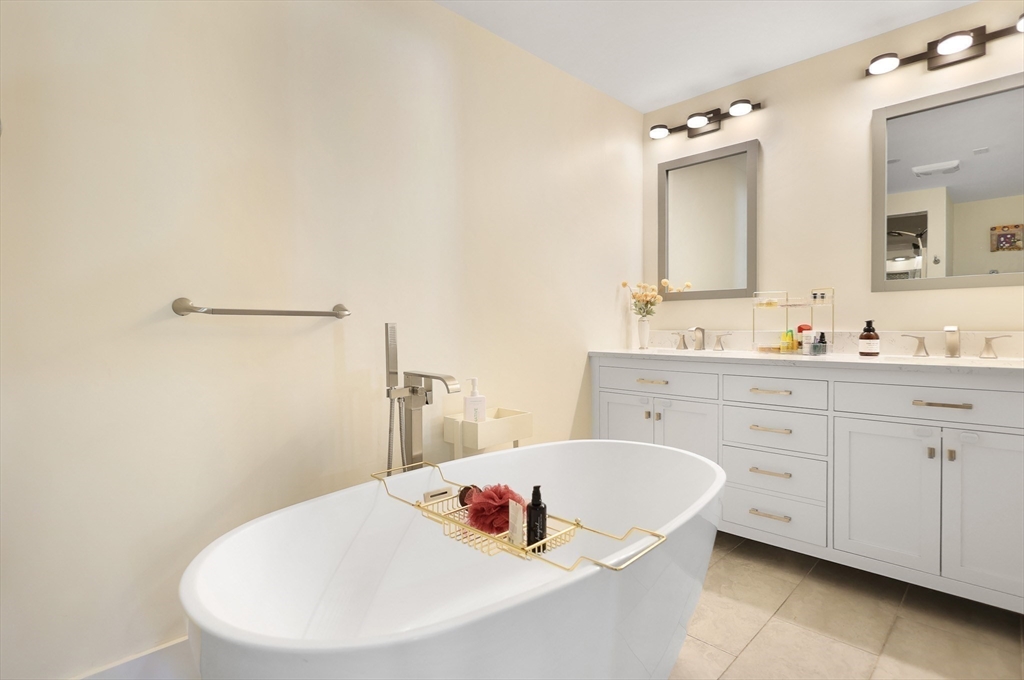 15 Whitman Road Medford, MA 02155 - Photo 17 of 39 a bathroom with a tub sink and mirror