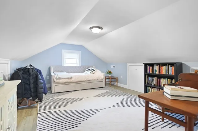 a living room with furniture and a book shelf