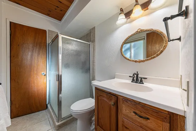 a bathroom with a sink a toilet and a mirror
