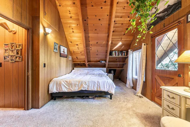 a spacious bedroom with a bed and a window