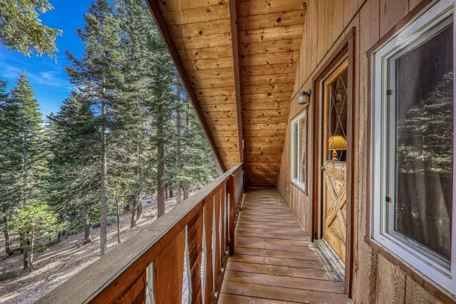 a view of balcony with wooden floor and fence