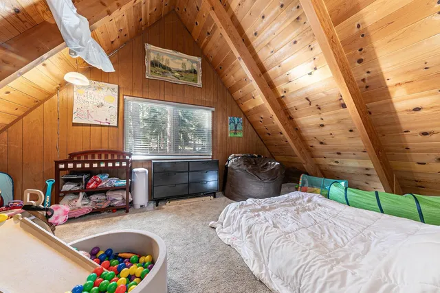 a bedroom with furniture and a wooden floor